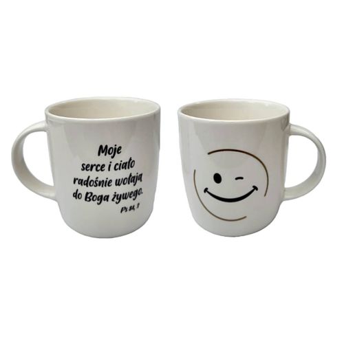 Ceramiczny kubek z cytatem biblijnym „Moje serce i ciało radośnie wołają do Boga żywego” Ps 84, 3 oraz uśmiechniętą mrugającą buźką, 330 ml, z efektem złocenia.