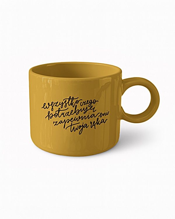 Musztardowy kubek ceramiczny z napisem "Wszystko czego potrzebuję zapewnia mi Twoja ręka" – symbol Bożej troski i opatrzności.