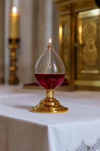 Lampka oliwna z czerwonym olejem liturgicznym – zapalona na ołtarzu przy tabernakulum